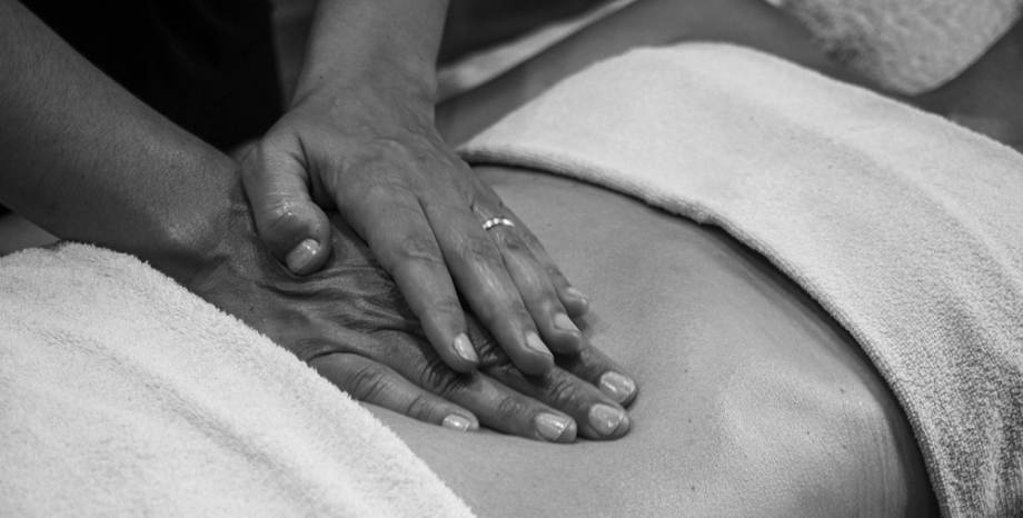 Woman undergoing abdominal massage therapy