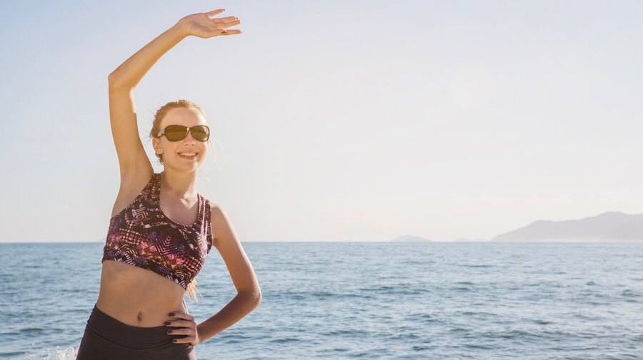 Woman stretching on the beach