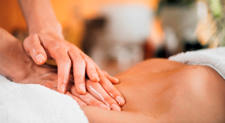 Woman receiving Abdominal Massage therapy