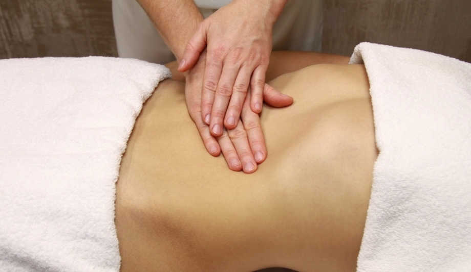 Woman receiving Chi Nei Tsang Abdominal Massage