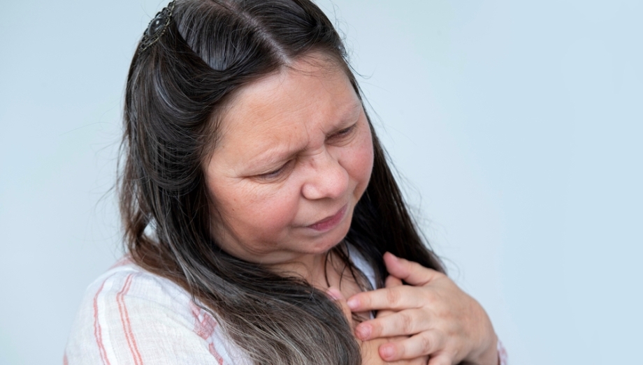 Woman holding chest because of grief