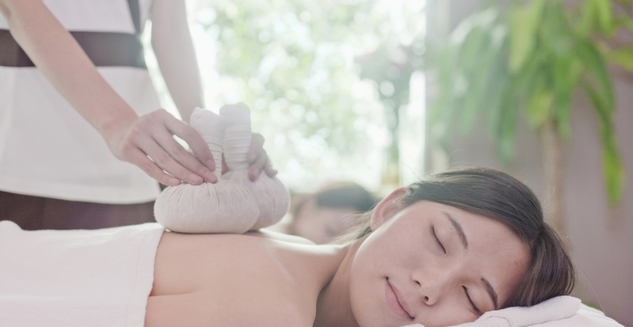 Woman receiving herbal Jamu Massage treatment