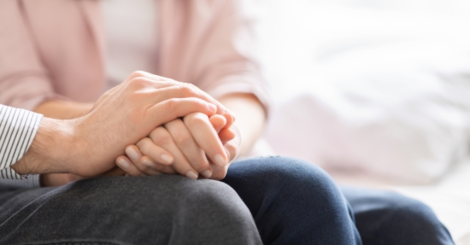 Woman giving support with hands to man