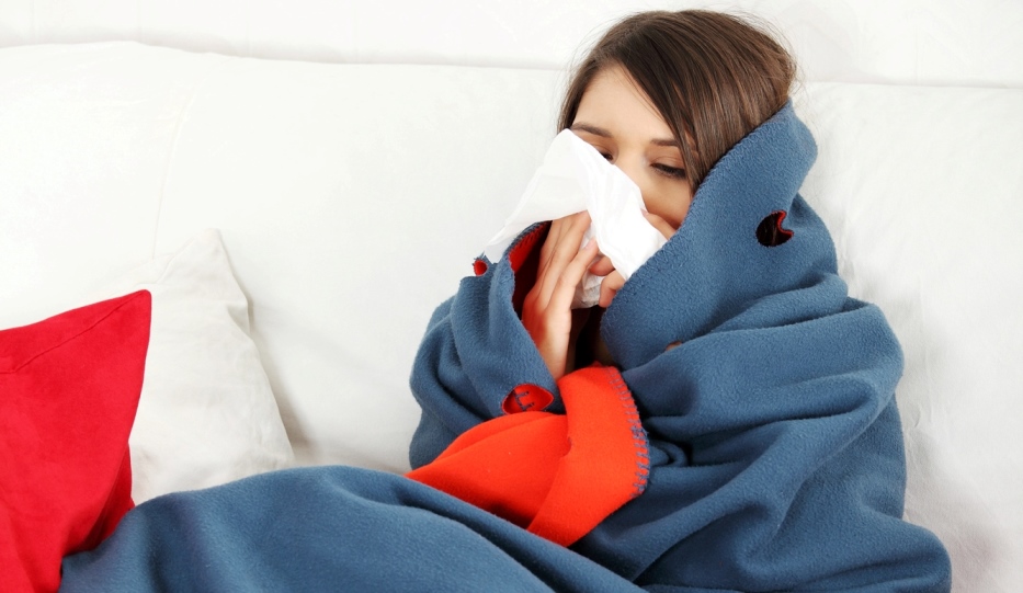 Woman with flu on couch