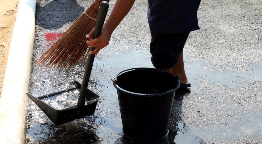 Thai person sweeping around house