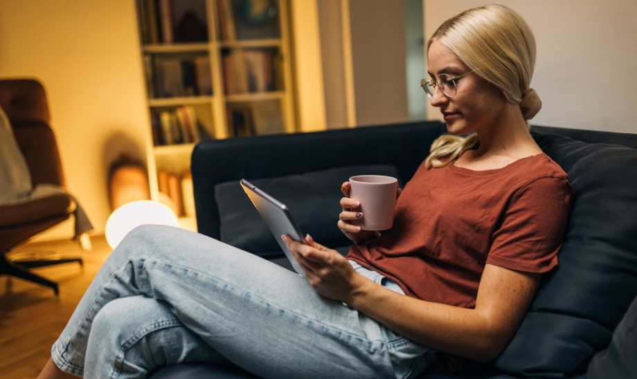 Woman reading eBook on couch