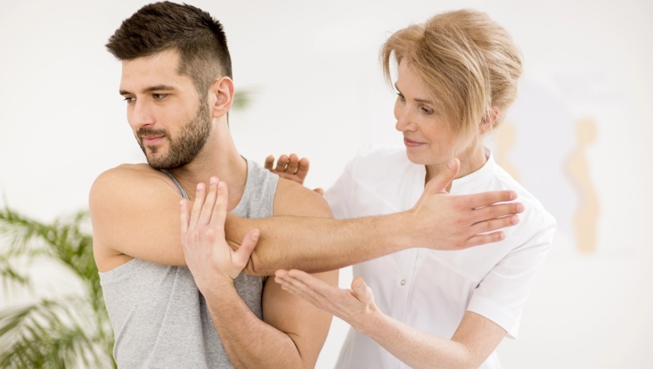 Male patient receiving physiotherapy