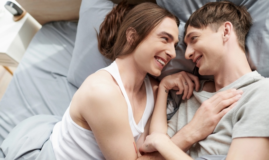 Two genderqueer people in bed