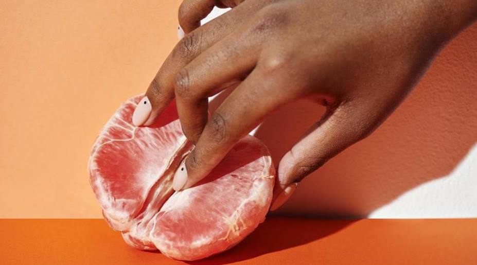 Woman touching fruit