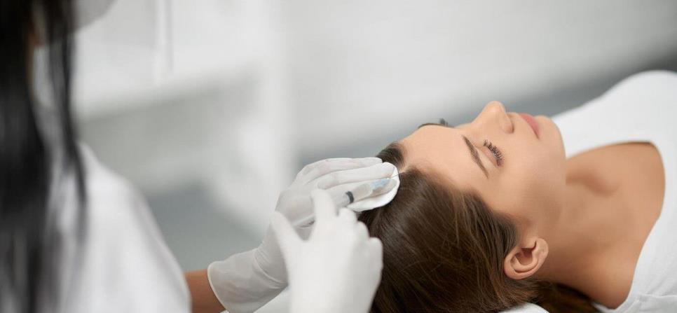 Woman undergoing hair growth treatment